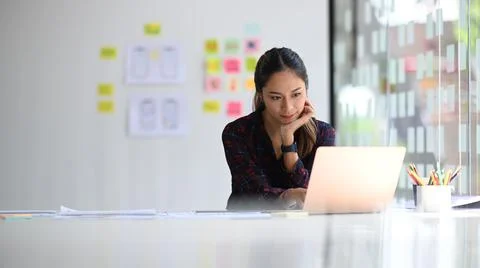 Concentrated female web developer working on mobile application software design Stock Photos