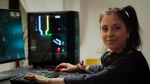 Concentrated gamer looking at camera while playing space shooter video game Stockfoto's