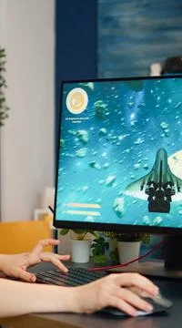 Concentrated gamer puting headset starting to play space shooter game Stock Photos