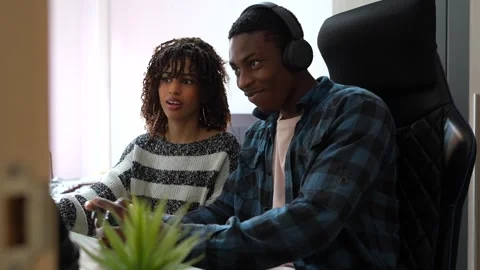 Concentrated gamers playing video games on computer Stock Footage 307290236