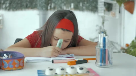 Concentrated girl does homework with colored markers Stock Footage 130479253