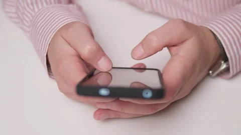 Concentrated Hands Utilizing a Smartphone Within a Professional Work Environment Stock Footage 289308923