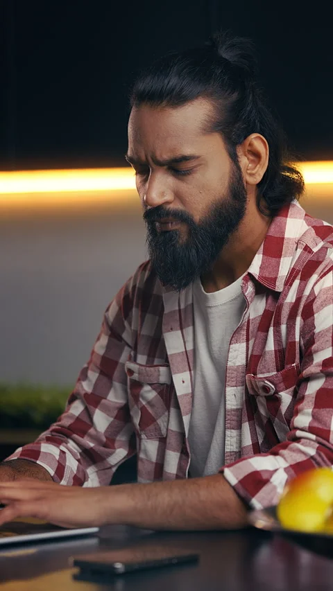 Concentrated Indian developer writing computer code on laptop at home office Stock Footage 316838125