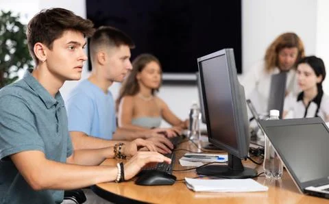 Concentrated junior software developer working in IT startup Foto stock