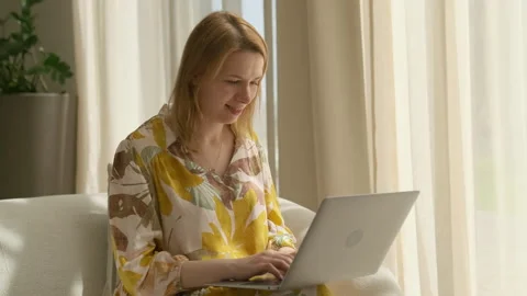 Concentrated lady employee types data on website via laptop Stock Footage 244650781