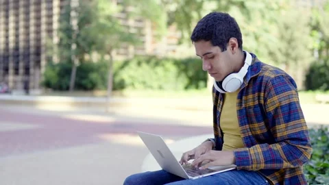 Concentrated latin student using laptop in the campus Stock Footage 258326222