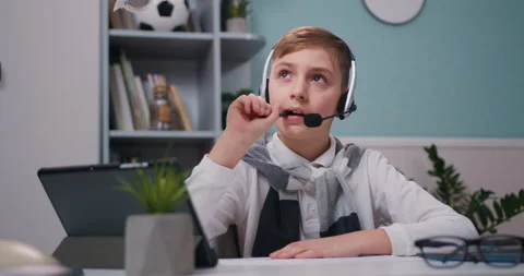 Concentrated little 19-10s kid boy wearing wireless headphones listening Stock Footage 231998982