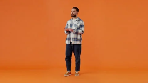 Concentrated male in basic shirt and jeans counting on fingers Video stock 259490059