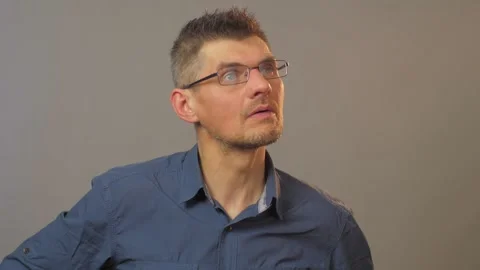 Concentrated man in glasses puts white disposable mask on Stock Footage 135131259
