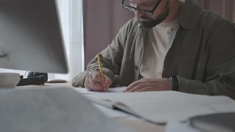 Concentrated man with glasses working on ideas, project at home office Stock Footage 137232562