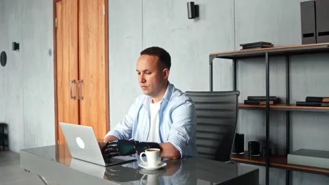 Concentrated man hacker with bio hand prothesis types Stock Footage 157330291