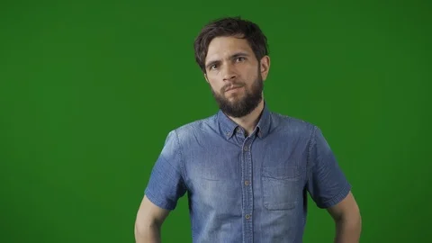 Concentrated man over a green screen background. Making some visible efforts to Stock Footage 115032040