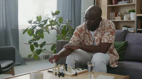 Concentrated Man Planning Moves during Solo Chess Practice at Home Stock Footage 290468044