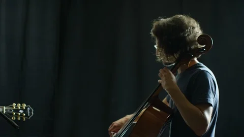 Concentrated man playing a cello Stock Footage 108937164