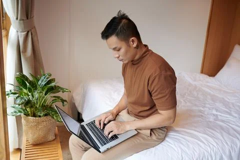 Concentrated Man Programming on Laptop Stock Photos