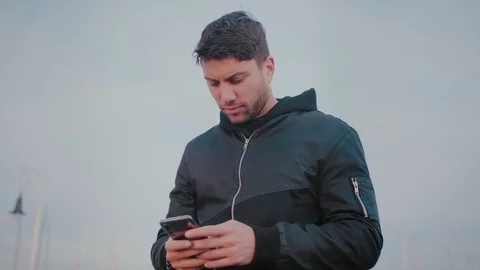 Concentrated man receive message or texting important email on smartphone app Video stock 101489441