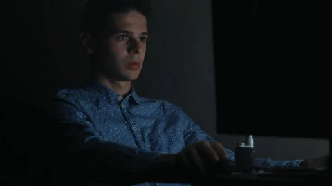 Concentrated man surfing in the internet on computer at home at night 動画素材 99051167