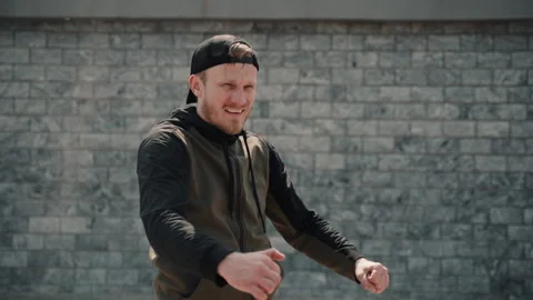 Concentrated man warming up stretching doing exercises on street in city on Stock-Footage 133214323
