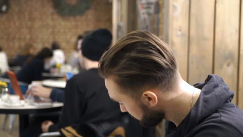 Concentrated man is working in cafe Stock Footage 86391906