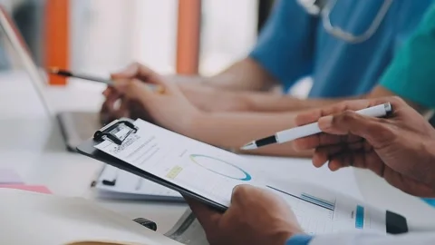 Concentrated medical team using laptop together in the office Stock Footage 242642914