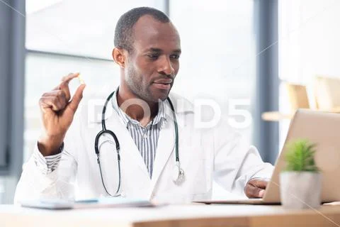 Concentrated medical worker recommending pills Stock Photos
