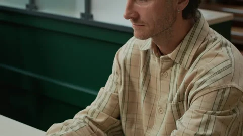 Concentrated Middle-Aged IT Specialist Working on Laptop in Modern Office Stock Footage 319996165