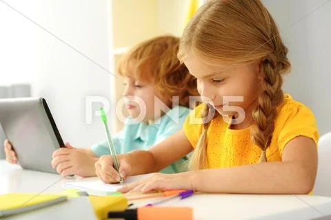 Concentrated modern children studying indoors Stock Photos