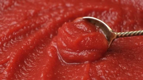 Concentrated natural tomato paste in a spoon, macro texture slow motion Stock Footage 313535363