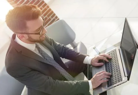 Concentrated professional IT developer with laptop 스톡 사진