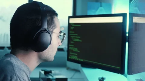 Concentrated Programmer Coding on a Computer Monitor  Stock Footage 144881032