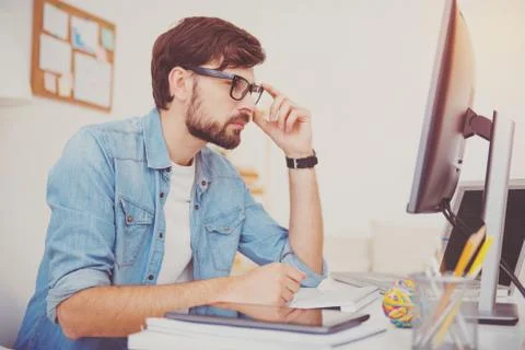 Concentrated programmer looking at the computer Foto stock