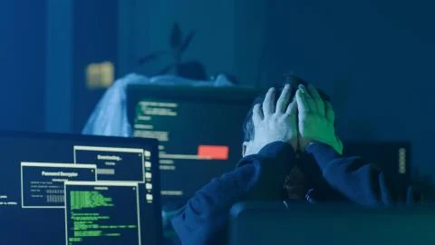 Concentrated programmer typing data codes on laptop looking at interface Stock Photos