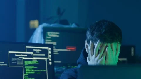 Concentrated programmer typing data codes on laptop looking at interface Stock Photos