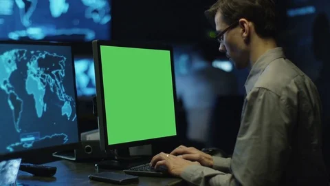 Concentrated Programmers Work on Personal Computers Located in a System Control  Stock Footage 70583144