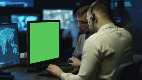 Concentrated Programmers Work on Personal Computers Located in a System Control  Stock Footage 70583924