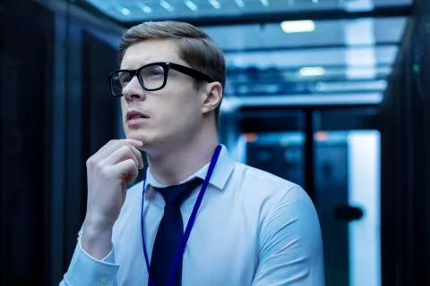 Concentrated smart young operator thinking Stock Photos