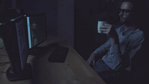 Concentrated tired programmer working at night Stock Footage 75018767