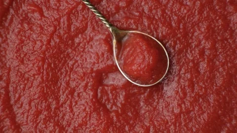 Concentrated Tomato Paste in a Spoon. Top View Rotate Stock Footage 313535431