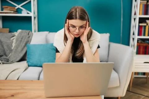 Concentrated woman have problems while working with laptop Freelance concept. Stock Photos