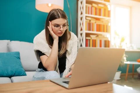 Concentrated woman have problems while working with laptop Freelance concept. Stock Photos