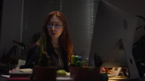 Concentrated Woman Working Late on Computer in Dark Office Stock Footage 338413721