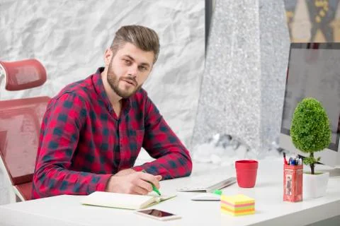 Concentrated on work. Concentrated young beard man working on laptop while 写真素材