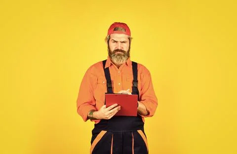 Concentrated on work. construction worker holding folder. Structural plan safety Stock Photos