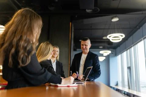 Concentrated workers write development plan at wooden table Stock Photos