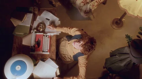 Concentrated Writer Smoking and Typing on Typewriter at Desk with Manuscripts Stock Footage 285084928