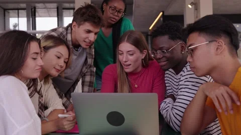 Concentrated young group of university student using laptop in the cafeteria on Stock Footage 263598220