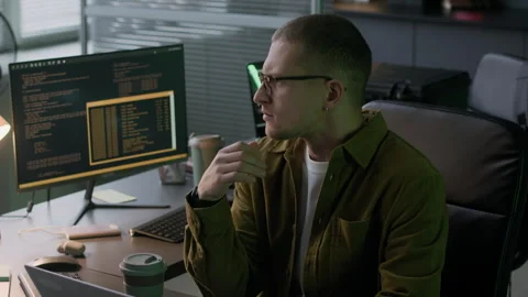 Concentrated Young Male Programmer Working Overnight in Computer Office Stock Footage 292618337