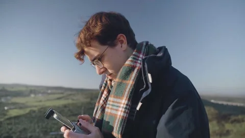 A concentrated young man flying a drone with the remote control. Stock Footage 240397340