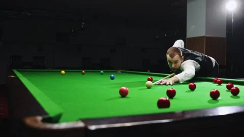 Concentrated young man leaning on billiards table, playing snooker game Stock Footage 266820594