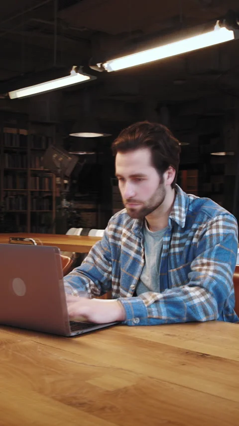 Concentrated young man spending time for scientific work at library Stock Footage 321413516